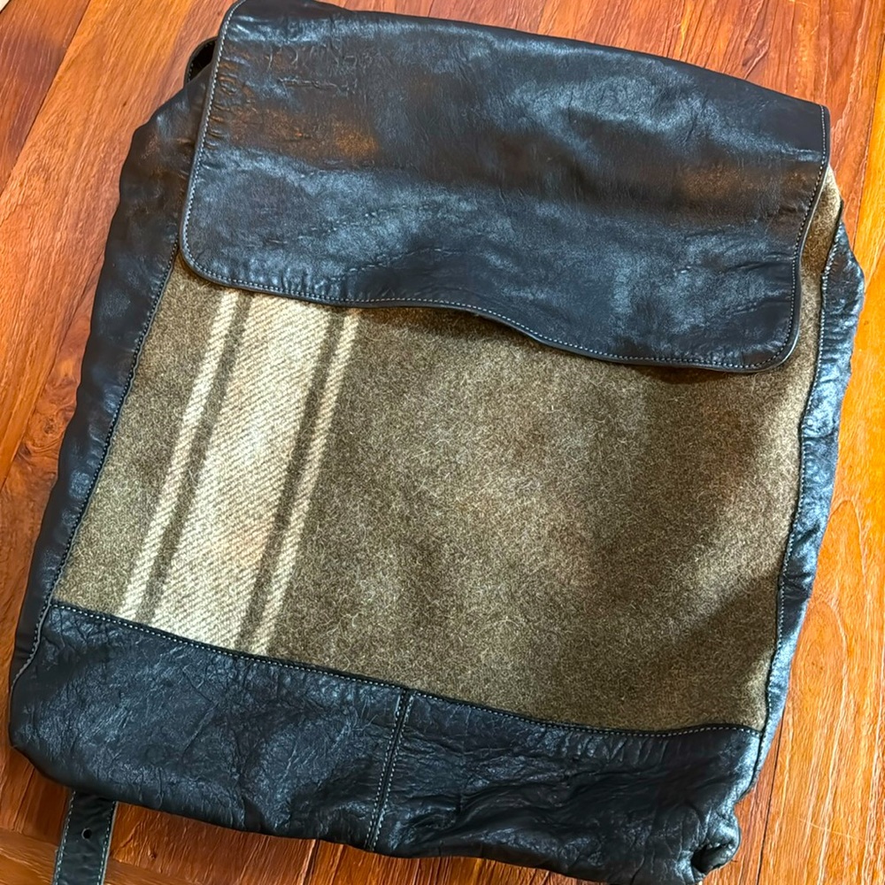 Soft leather and wool backpack. Fabric is olive green and beige.